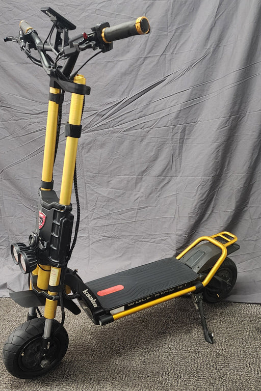 Yellow and black scooter on a gray surface