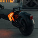 Close-up of a scooter's rear light and reflector on a dark background