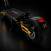 Black electric scooter with gold accents on a dark background