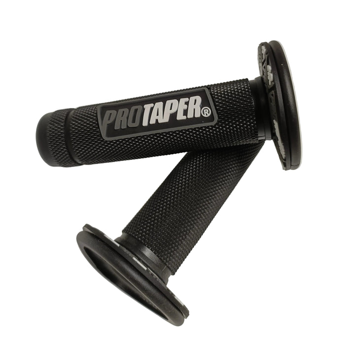 Two black textured motorcycle handlebar grips with round black end caps, featuring a central logo plate that reads 'PROTAPER' in white text, displayed on a white surface.